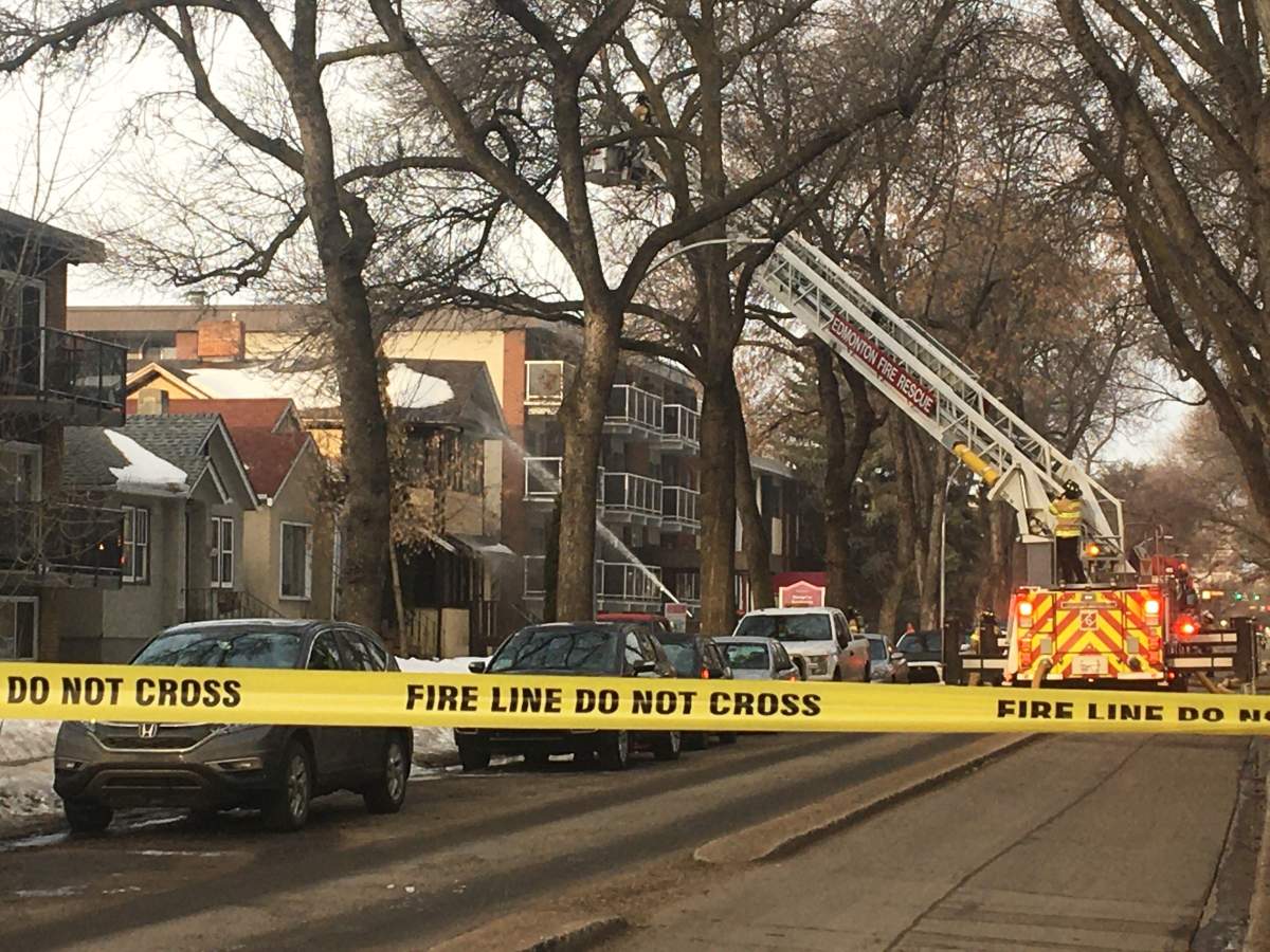 Fire crews battle a blaze at an unoccupied house on 83 Avenue between 100 and 101 streets Friday, March 27, 2020.