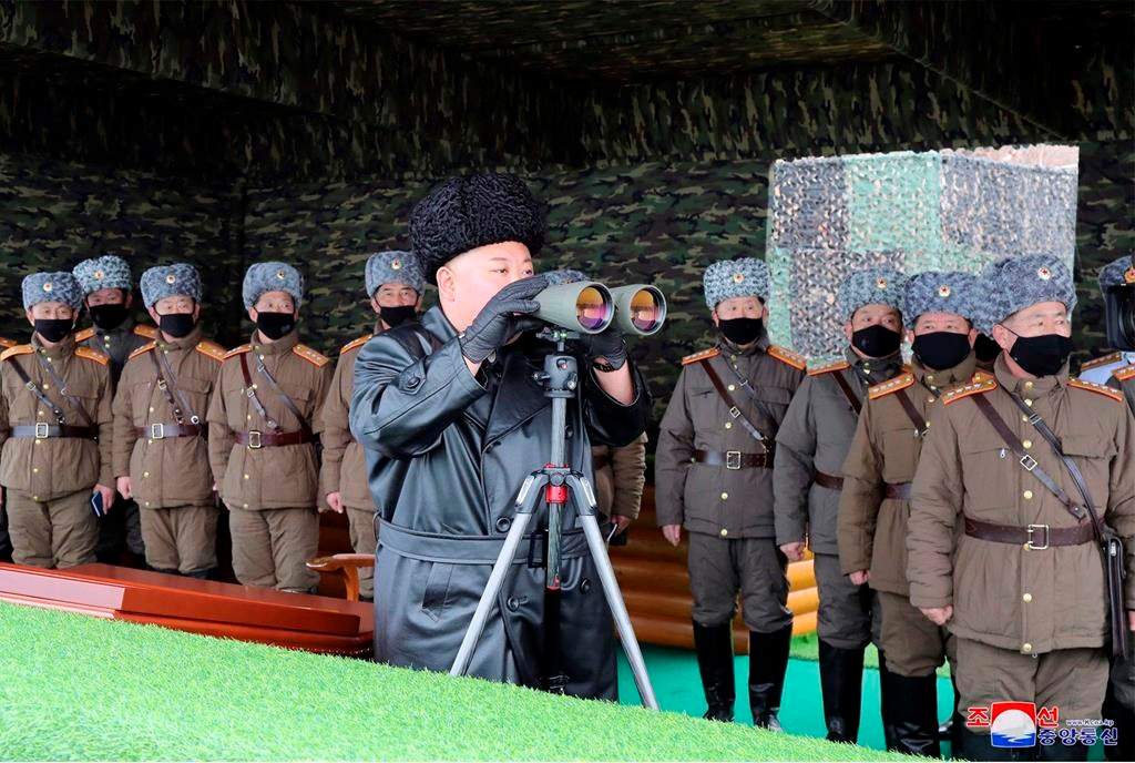 In this Friday, Feb. 28, 2020, file photo provided on Feb. 29, 2020 by the North Korean government, North Korean leader Kim Jong Un, center, inspects the military drill of units of the Korean People's Army, with soldiers shown wearing face masks. South Korea’s military says North Korea has fired at least one unidentified projectile.