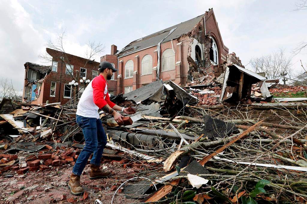 Sumant Joshi helps to clean up rubble at the East End United Methodist Church after it was heavily damaged by storms Tuesday, March 3, 2020, in Nashville, Tenn.