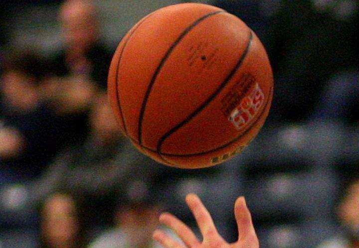 File: A photo of a basketball in the air.