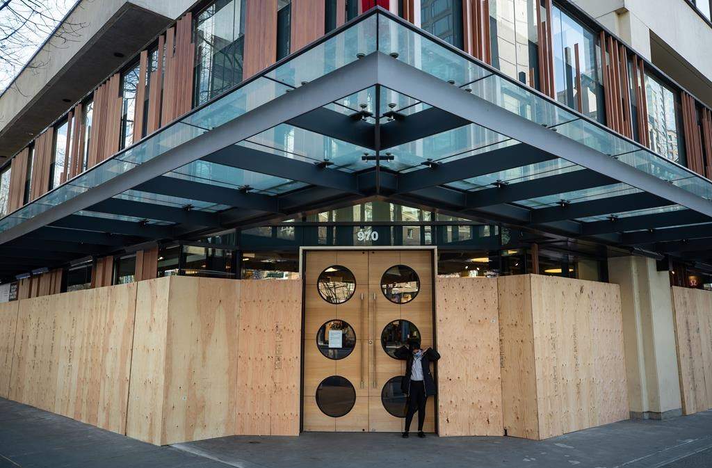 A Lululemon store with boarded up windows that has been closed due to the coronavirus, is seen in downtown Vancouver, on Wednesday, March 25, 2020.
