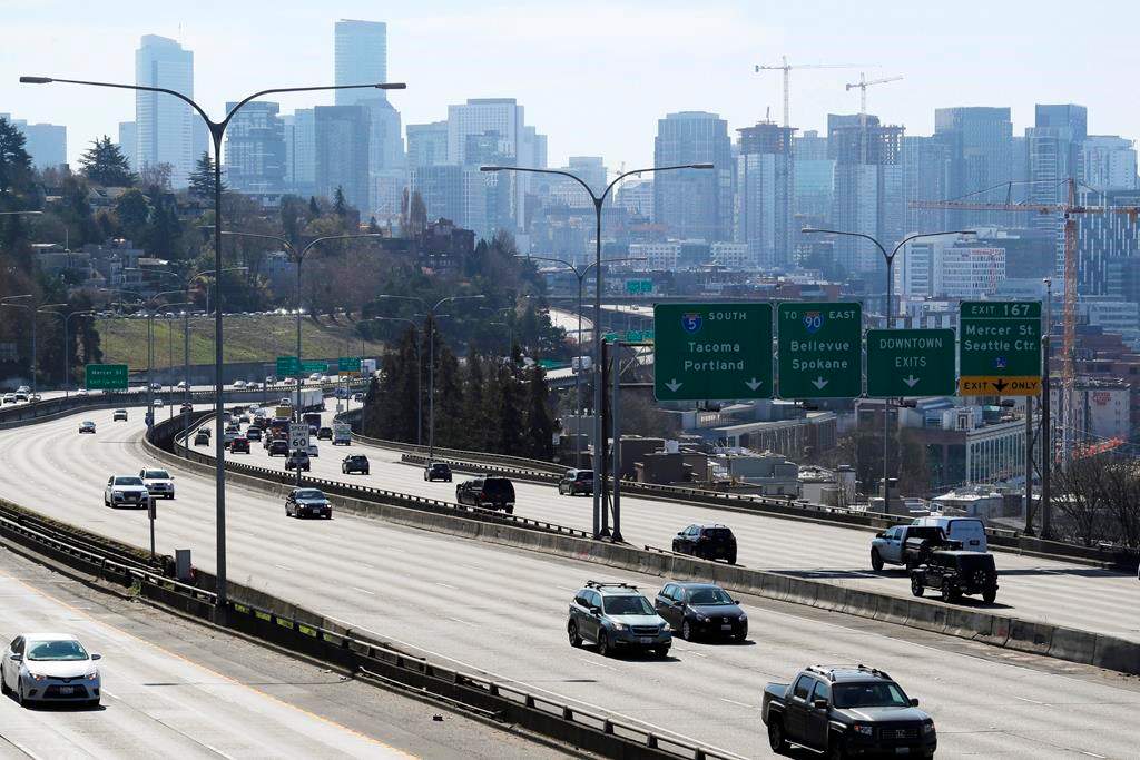 Early afternoon traffic is thin on Interstate 5 north of downtown Seattle, Friday, March 20, 2020. With many people working from home or otherwise not traveling, Seattle's notorious traffic has been minimal during the outbreak of the new coronavirus.