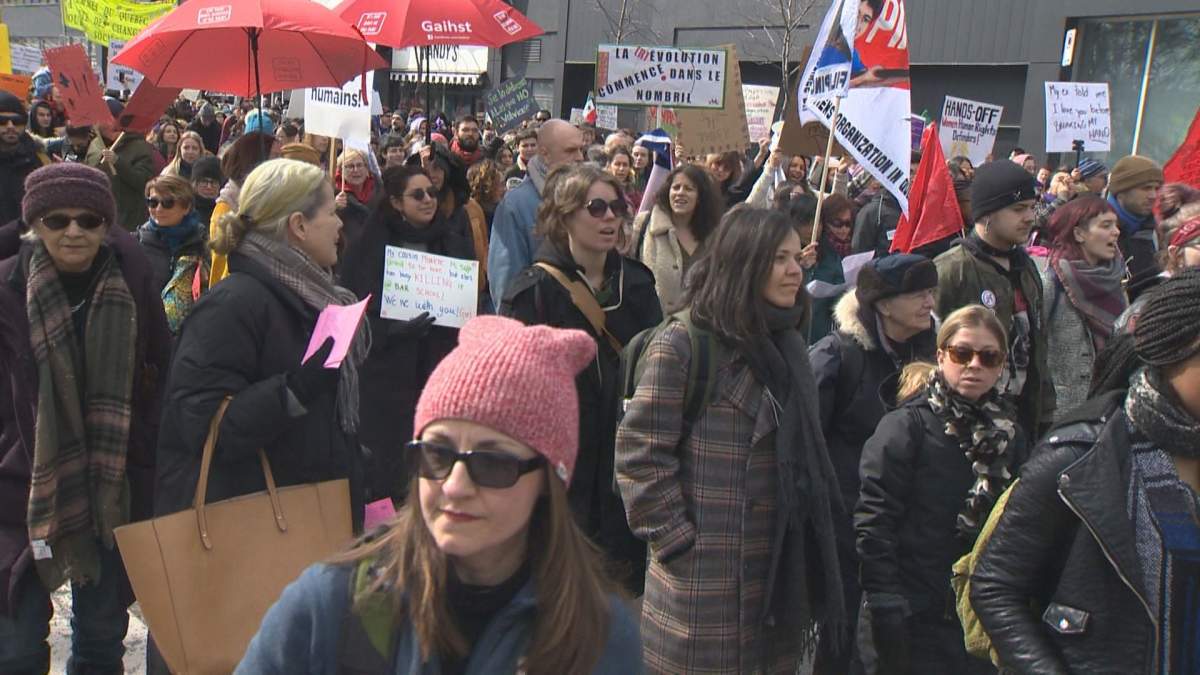 Protesters walk along the streets of downtown Montreal on Sunday, March 8, 2020.