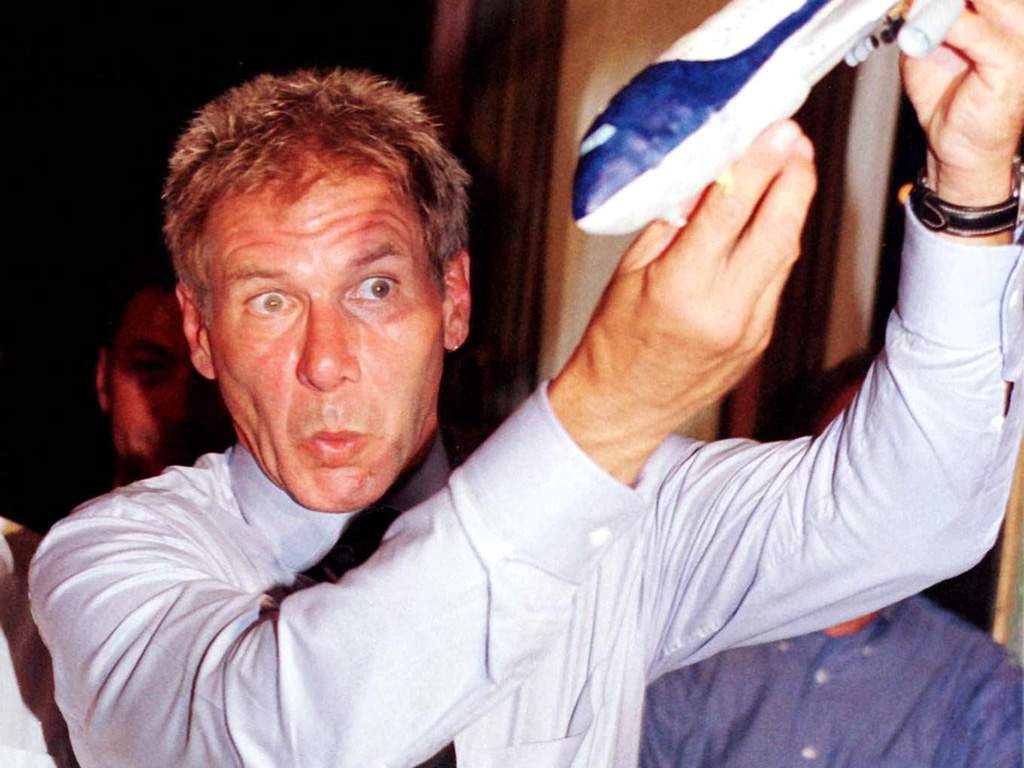 Harrison Ford toying with a model plane during a late-night ceremony at Pisani Moretta Palace following the presentation of his latest movie ‘Air Force One,’ Sept. 2 1997.