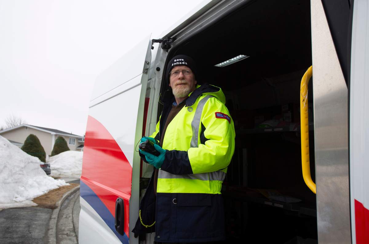 Craig Dyer, a postal worker, is back on the job delivering mail in Mount Pearl, Nfld., on Friday, April 3, 2020 following a two week isolation period when a co-worker tested positive for COVID 19. 
