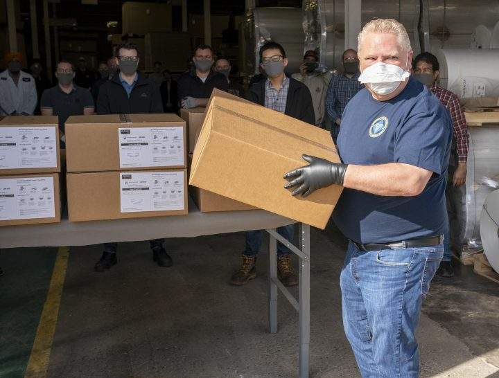 Ontario Premier Doug Ford loads ASTM Level 3 masks made by The Woodbridge Group in Woodbridge, Ont. on Tuesday, April 7, 2020.