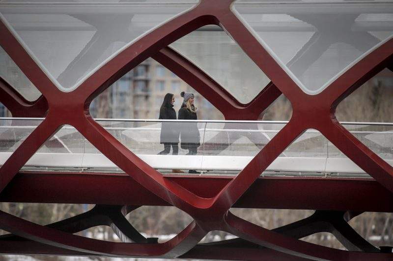 People practice physical distancing in Calgary, Alta., Thursday, April 9, 2020, amid a worldwide COVID-19 pandemic. 
