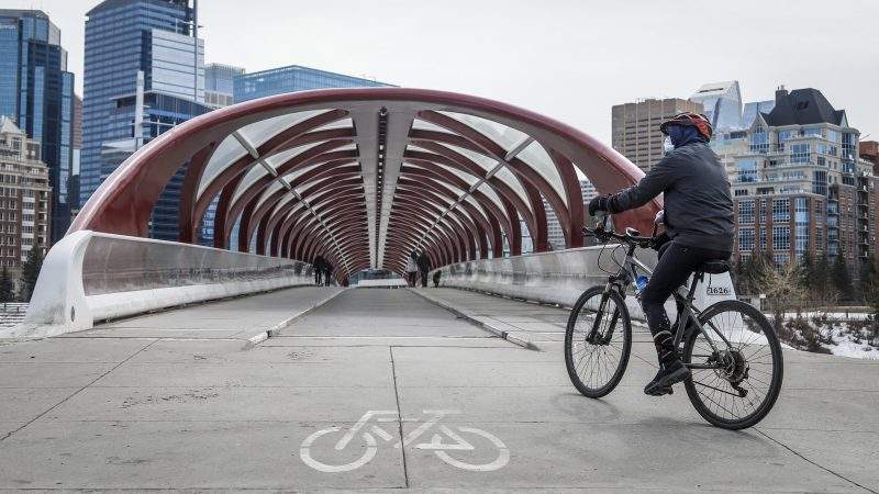 People practice physical distancing in Calgary, Alta., Thursday, April 9, 2020, amid a worldwide COVID-19 pandemic. 