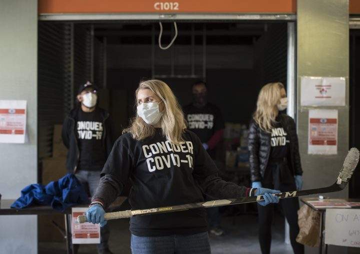 Olympian Hayley Wickenheiser reacts as a vehicle approaches the donation drive for personal protective equipment at XYZ Storage in Toronto on Saturday, April 11, 2020, amid the COVID-19 global pandemic.