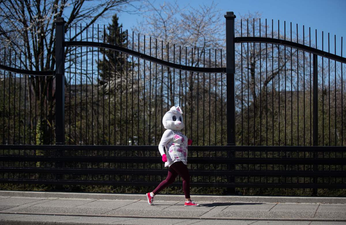 A person wearing an Easter bunny costume walks along Commercial Drive in Vancouver on Sunday, April 12, 2020. 