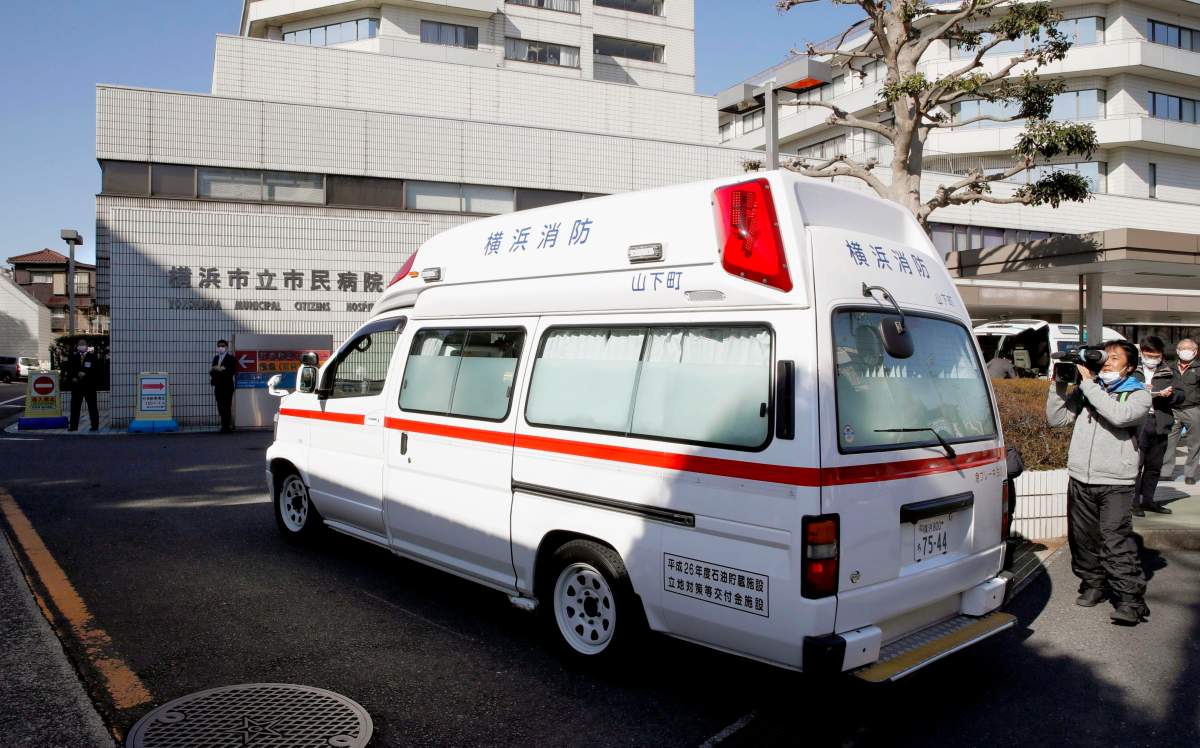 In this Feb. 5, 2020, photo, an ambulance carrying a passenger onboard cruise ship Diamond Princess arrives at a hospital in Yokohama, near Tokyo.