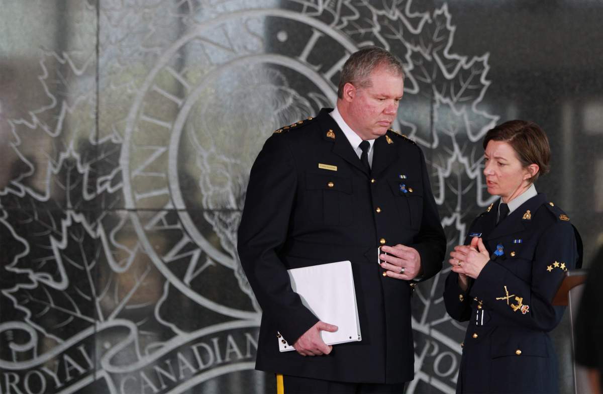 Nova Scotia RCMP Public Information Officer Cpl. Jennifer Clarke, right, prepares to translate a response by Nova Scotia RCMP Criminal Operations Officer Chief Superintendent Chris Leather, on a query from a French language reporter during a news conference at Nova Scotia RCMP headquarters in Dartmouth, N.S. on Wednesday 22, 2020. The RCMP say they have confirmed that the shooter behind a weekend rampage in Nova Scotia that left 22 victims dead acted alone. 