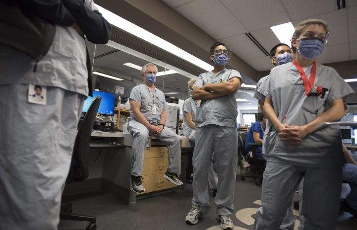 BC Dr. Del Dorscheid, centre, takes part in board rounds in the COVID-19 intensive care unit at St. Paul’s hospital in downtown Vancouver, Tuesday, April 21, 2020.