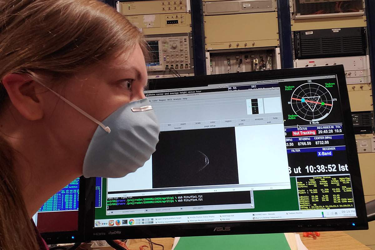 Anne Virkki, head of Planetary Radar at the Arecibo Observatory, and Asteroid 1998 OR2 pose with their masks.