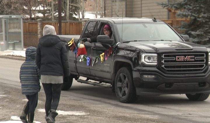 Birthday boy Robbie Maley and mom Kamie Densmore accept a gift from a vehicle on Sunday, April 5, 2020.