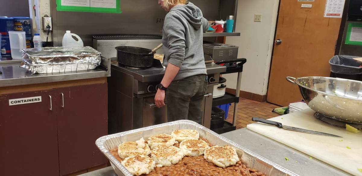 A volunteer at Brunswick Street Mission prepares lunch.