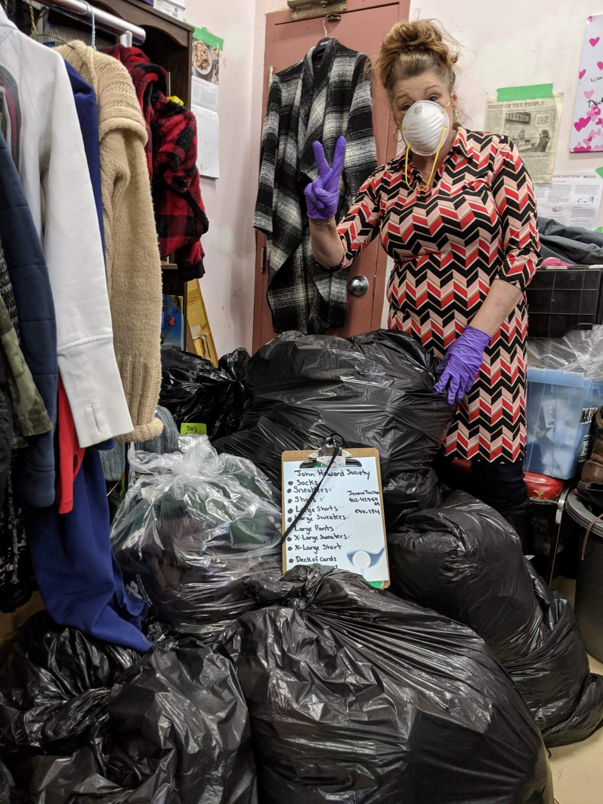 A Brunswick Street Mission volunteer safely sorts through donations.