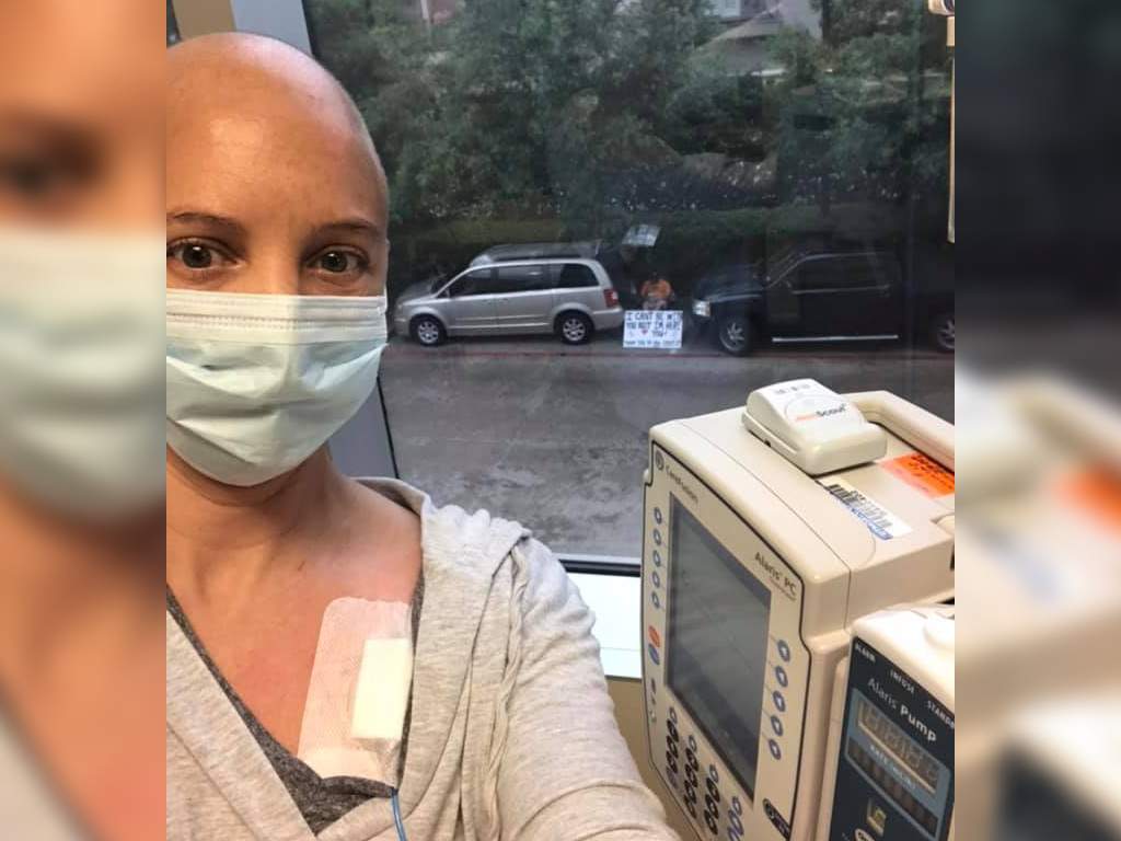 Kelly Conner can't see visitors during her chemotherapy treatments, so her husband, Albert, sits outside the hospital with supportive signs.