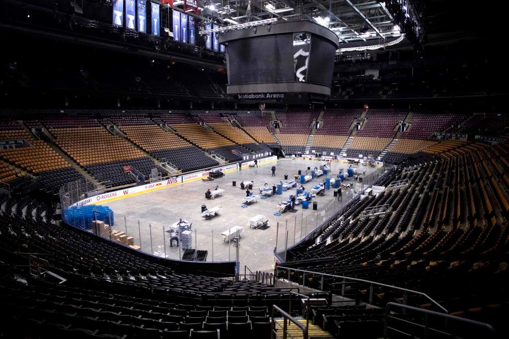 MLSE employees put together meals as they work on the floor of Scotiabank Arena, in Toronto on Wednesday, April 22, 2020. The meals are being donated as part of an initiative with partners such as Second Harvest, and are being distributed to front-line workers and homeless shelters during the COVID-19 pandemic. THE CANADIAN PRESS/Chris Young
