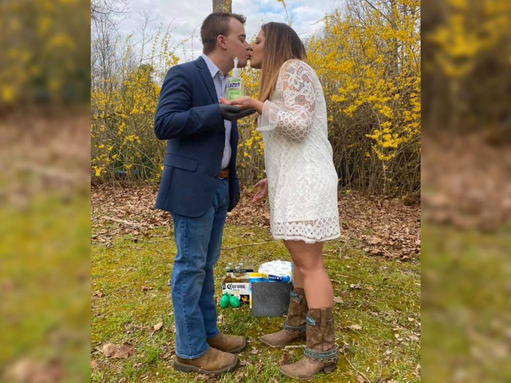 The couple shared a kiss holding onto a bottle of Purell hand sanitizer.