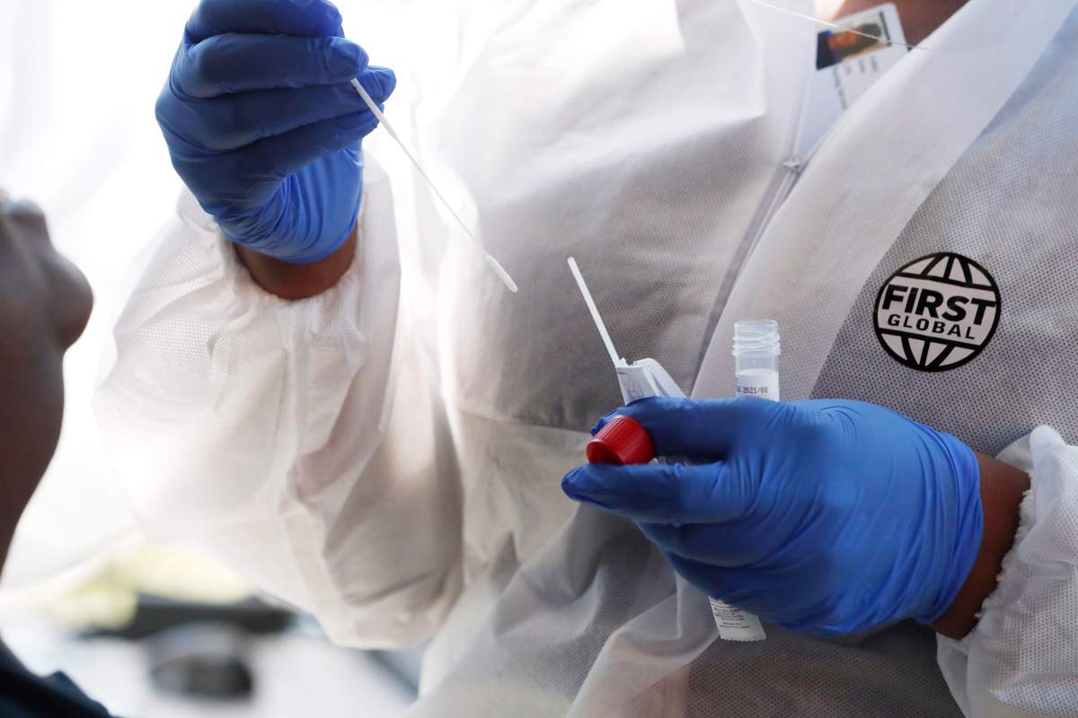 A nurse prepares to administer a COVID-19 test.