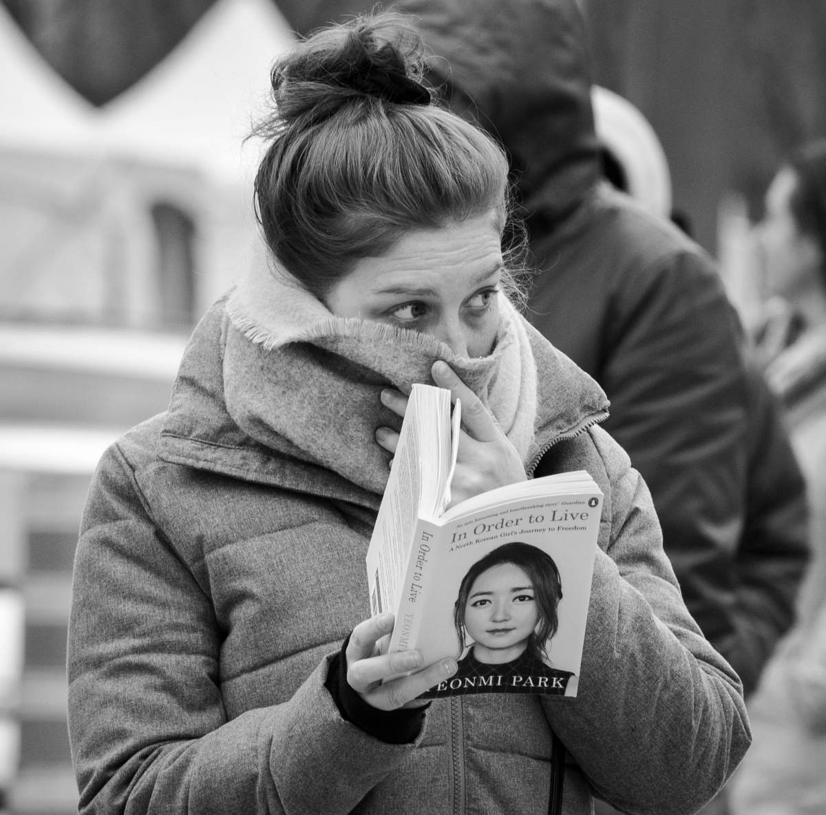 A woman wears a scarf over her nose while waiting to get tested at a COVID-19 screening clinic, Monday March 23, 2020. Phil Carpenter/Global News