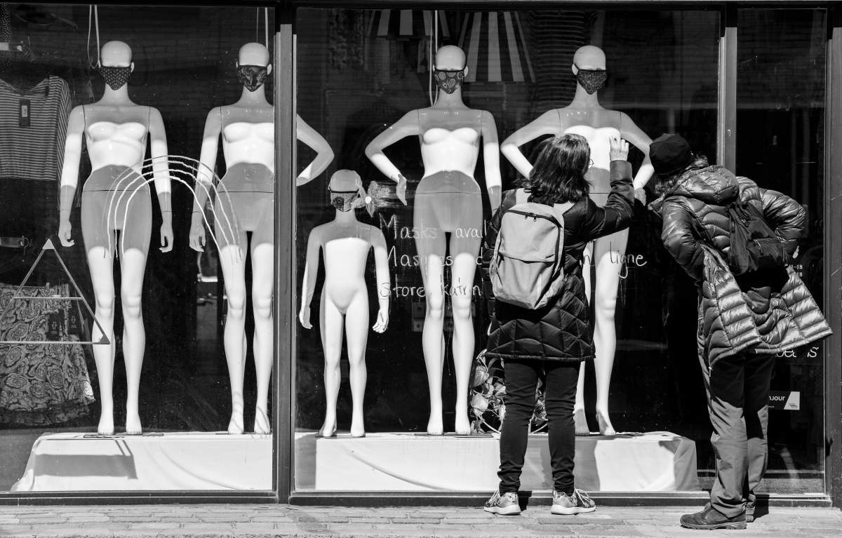 Two women look at face masks at clothing store on St-Laurent Boulevard in Montreal, Saturday April 4, 2020. Phil Carpenter/Global News