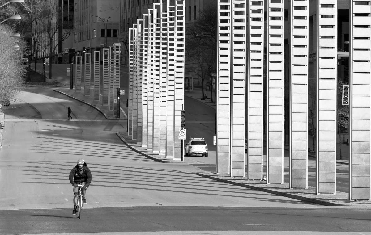 A cyclist rides alone south on Robert Bourassa Boulevard, Saturday April 4, 2020, as streets remain largely empty as people self-isolate at home. Phil Carpenter/Global News.