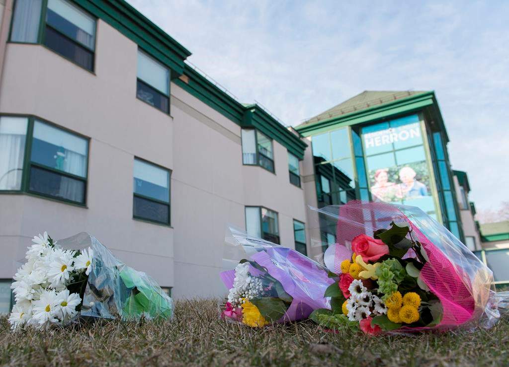Flowers are shown outside Maison Herron, a long-term care home in the Montreal suburb of Dorval, Sunday, April 12, 2020.