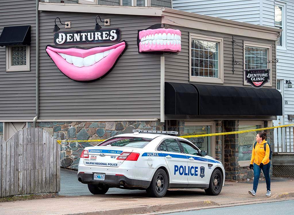 The Atlantic Denture Clinic is guarded by police in Dartmouth, N.S. on Monday, April 20, 2020. THE CANADIAN PRESS/Andrew Vaughan