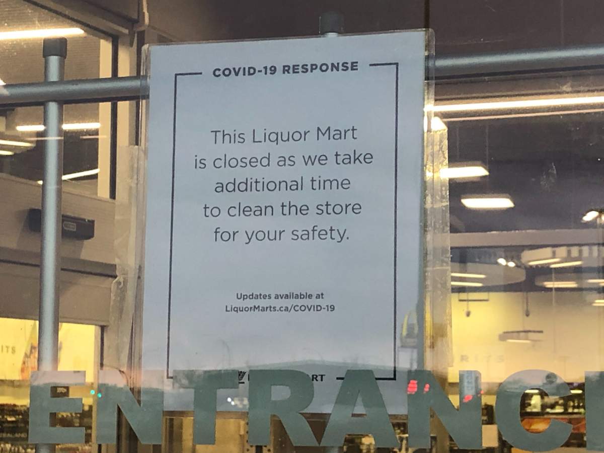 A sign on the door of the Garden City Liquor Mart.