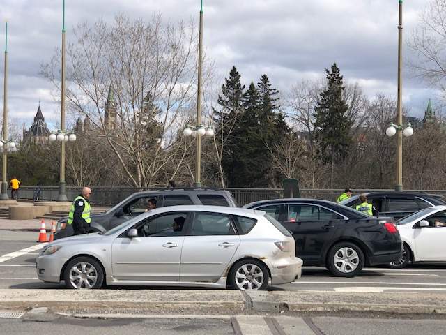 Gatineau police officers question drivers entering Quebec from Ontario amid the COVID-19 pandemic on Wednesday, April 1, 2020