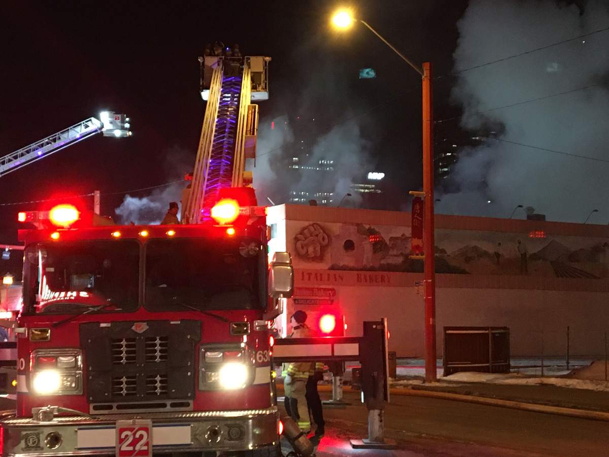 Fire crews work to douse a blaze at a building that houses the Italian Bakery, on 97 Street and 106 Avenue Friday, April 3, 2020.