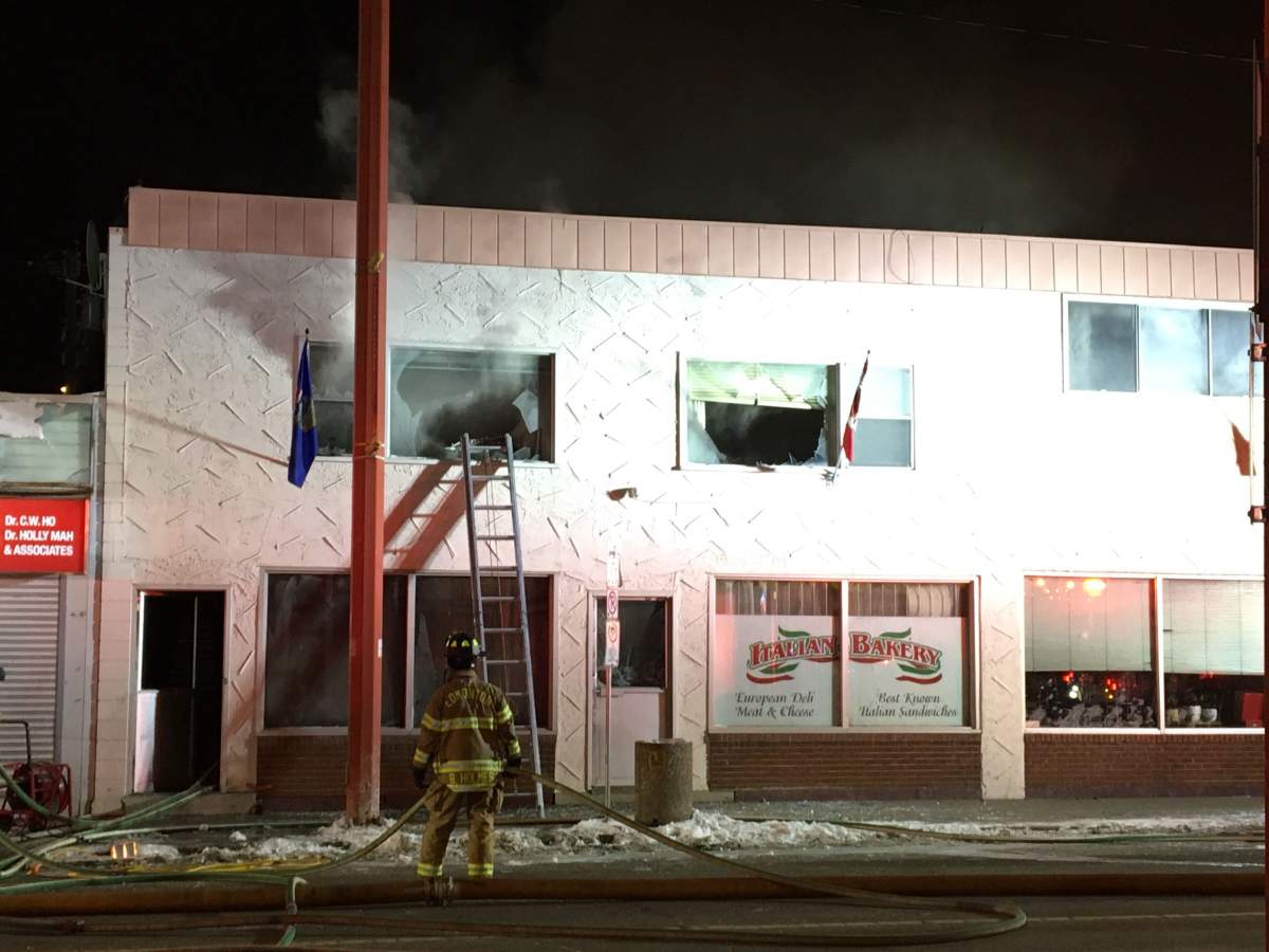 Fire crews work to douse a blaze at a building that houses the Italian Bakery, on 97 Street and 106 Avenue Friday, April 3, 2020.