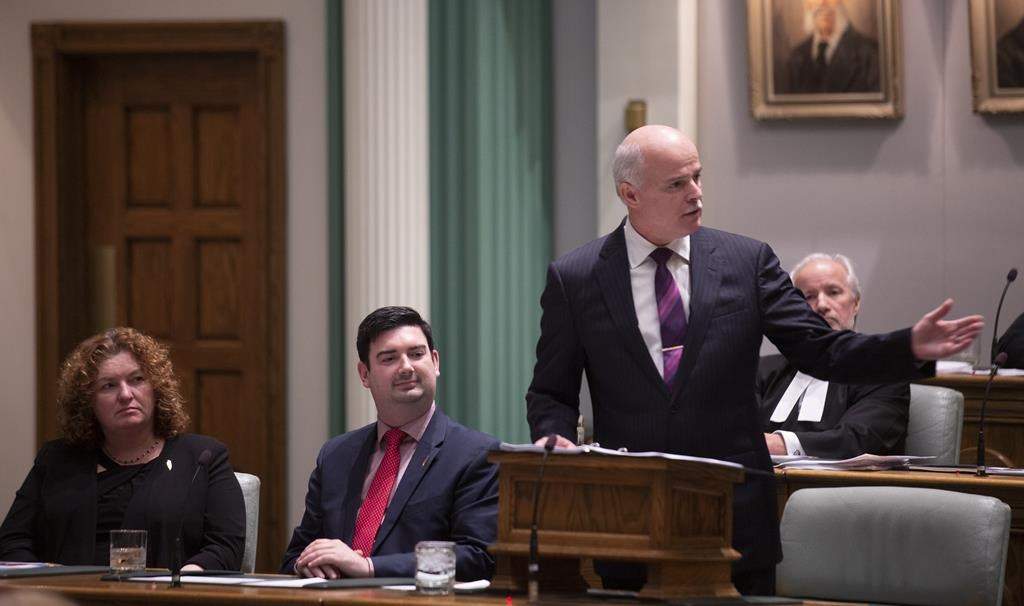 Sherry Gambin-Walsh, Minister of Service, left to right, and Christopher Mitchelmore, Minister of Tourism, Culture and Innovation listen as Finance Minister Tom Osborne presents the 2019 Budget in the House of Assembly in St. John's on April 16, 2019.