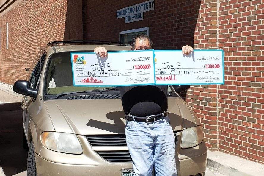 'Joe B.' of Pueblo, Colo., shows off his two million-dollar prizes outside the Colorado Lottery office on Apr. 27, 2020.