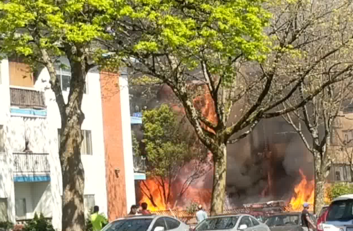Flames shoot out of a Vancouver apartment building on April 18, 2020.