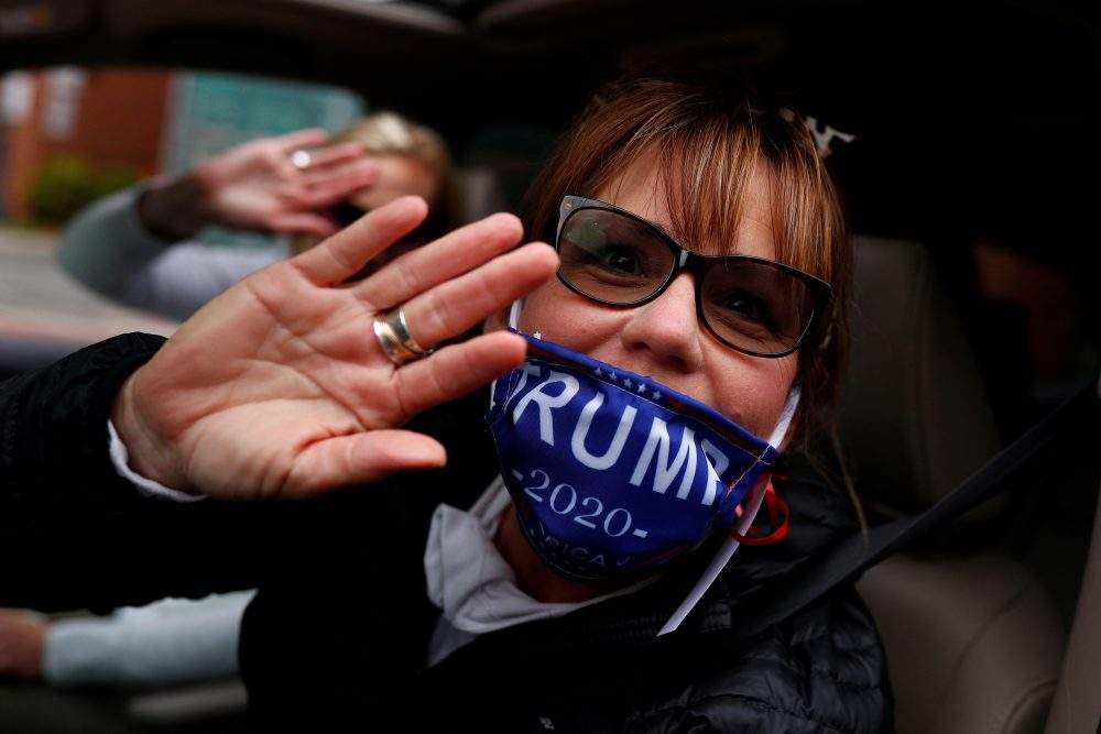 A person wearing a Trump custom face mask yells out of a car window during a demonstration calling for the re-opening of the state of Maryland amidst the coronavirus disease (COVID-19) outbreak, in Annapolis, Md., on April 18.