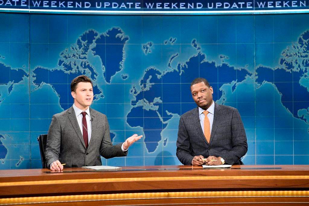 This Feb. 29, 2020 photo released by NBC shows Colin Jost, left, and Michael Che during the Weekend Update sketch on "Saturday Night Live" in New York. The show will be back on the air this weekend with a show that abides by social distancing rules. NBC says the comedy sketch show will include include a “Weekend Update” news segment and original content from “SNL” cast members. The material will be produced remotely, in compliance with efforts to limit the spread of the coronavirus. (Will Heath/NBC via AP).