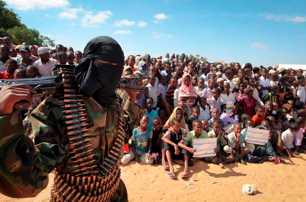 FILE – In this Feb. 13, 2012, file photo, an armed member of the militant group al-Shabab attends a rally on the outskirts of Mogadishu, Somalia. (AP Photo, File)