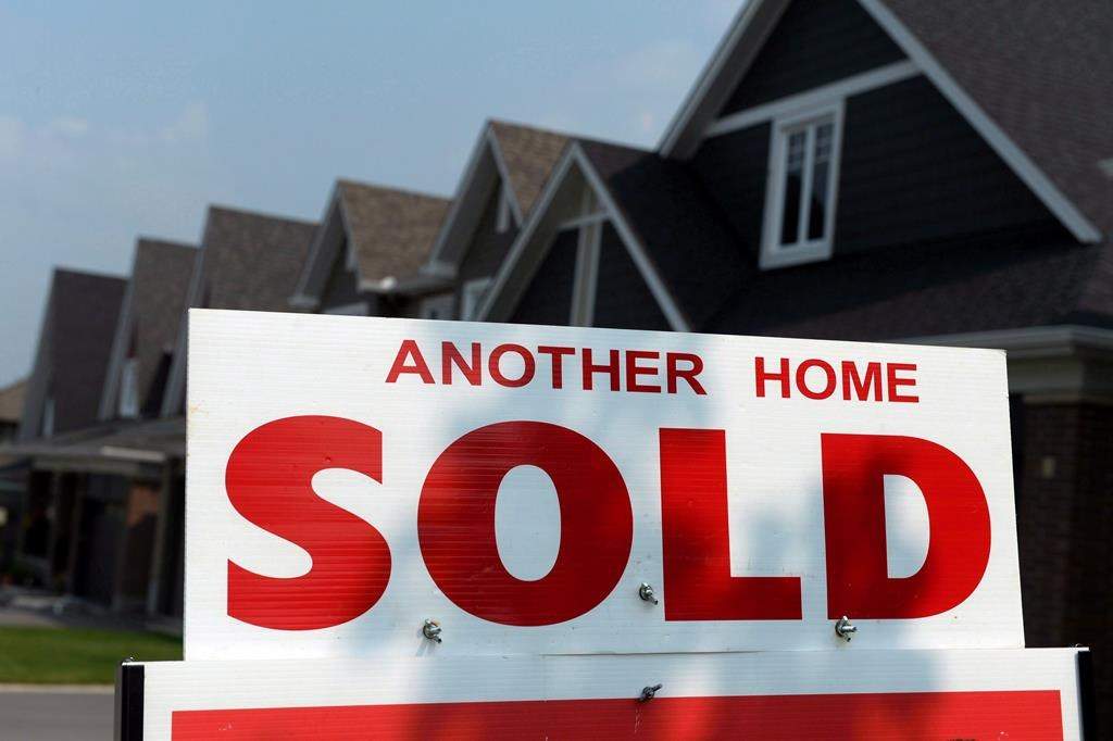 A sign displays a home that has been sold in a development in Ottawa on July 6, 2015.