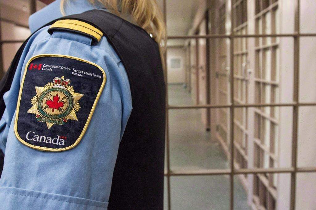 A correctional officer looks on at the Collins Bay Institution in Kingston, Ont., on Tuesday, May 10, 2016, during a tour of the facility.