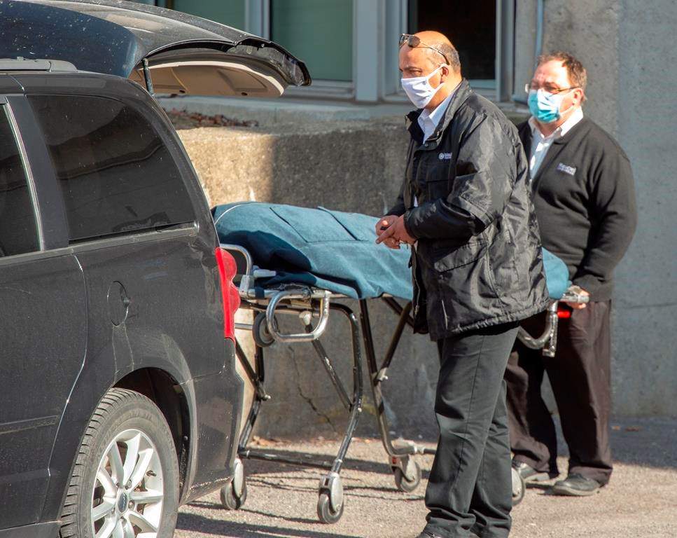 Funeral home workers remove a body from the Centre d'hebergement Sainte-Dorothee Friday April 17, 2020 in Laval Que.