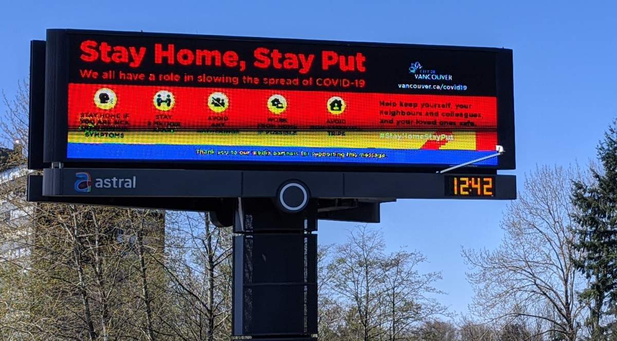 An illuminated sign in Vancouver asks residents to stay home during the COVID-19 pandemic. 