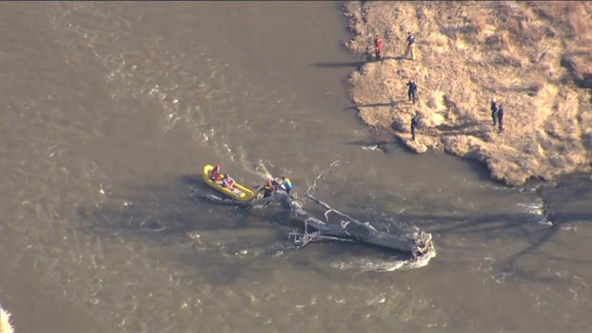 Calgary firefighters rescue two men who became stranded on a fallen tree in the Bow River on Tuesday, April 21, 2020. 