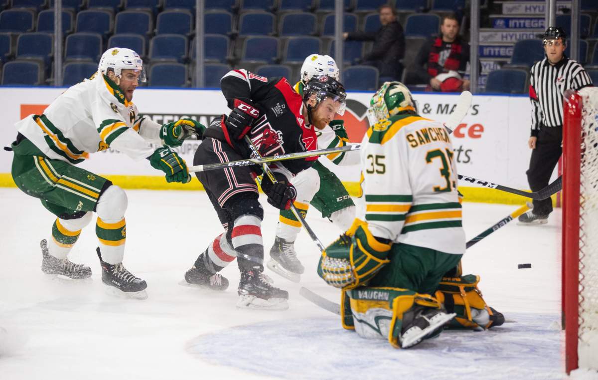 UNB Reds' Christopher Clapperton gets stopped by University of Alberta Golden Bears goaltender Zach Sawchenko during the U Sports Men's Hockey final, in Lethbridge, Alta., Sunday, March 17, 2019. 