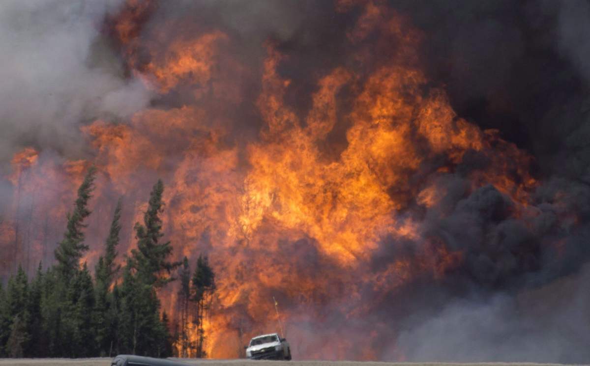A giant fireball is seen as a wildfire rips through the forest 16 kilometres south of Fort McMurray, Alta. on Highway 63 Saturday, May 7, 2016.