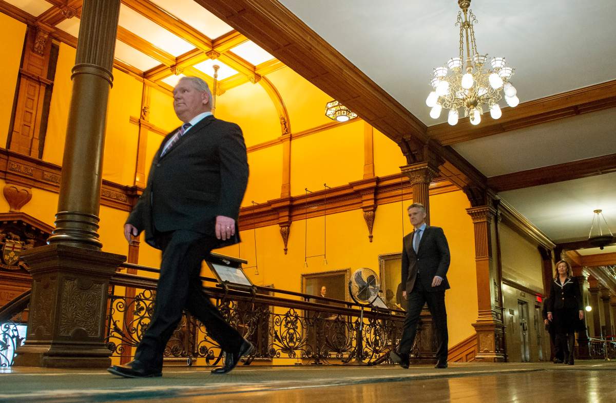 Ontario Premier Doug Ford, Finance Minister Rod Phillips and Health Minister Christine Elliott walk to the daily briefing at Queen's Park in Toronto, Monday, April 27, 2020. 