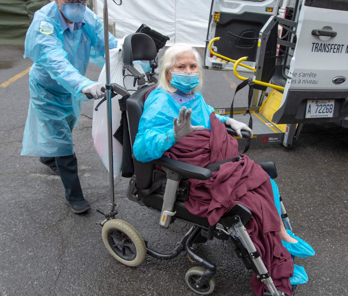 A resident waves as she is brought into the Vigi Mount Royal seniors residence on Friday May 1, 2020 in Montreal.