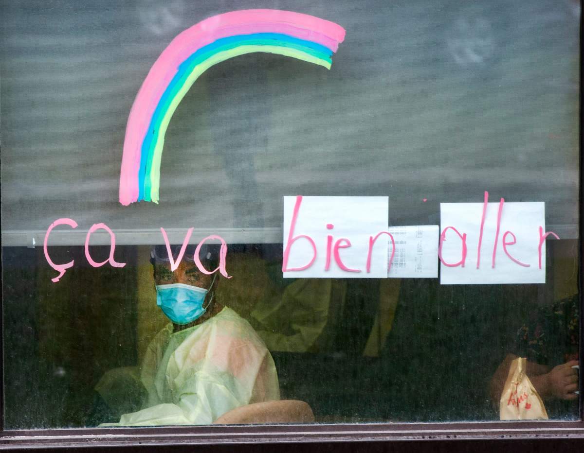 A worker looks out the window at the Vigi Mount Royal seniors residence Friday May 1, 2020 in Montreal. 